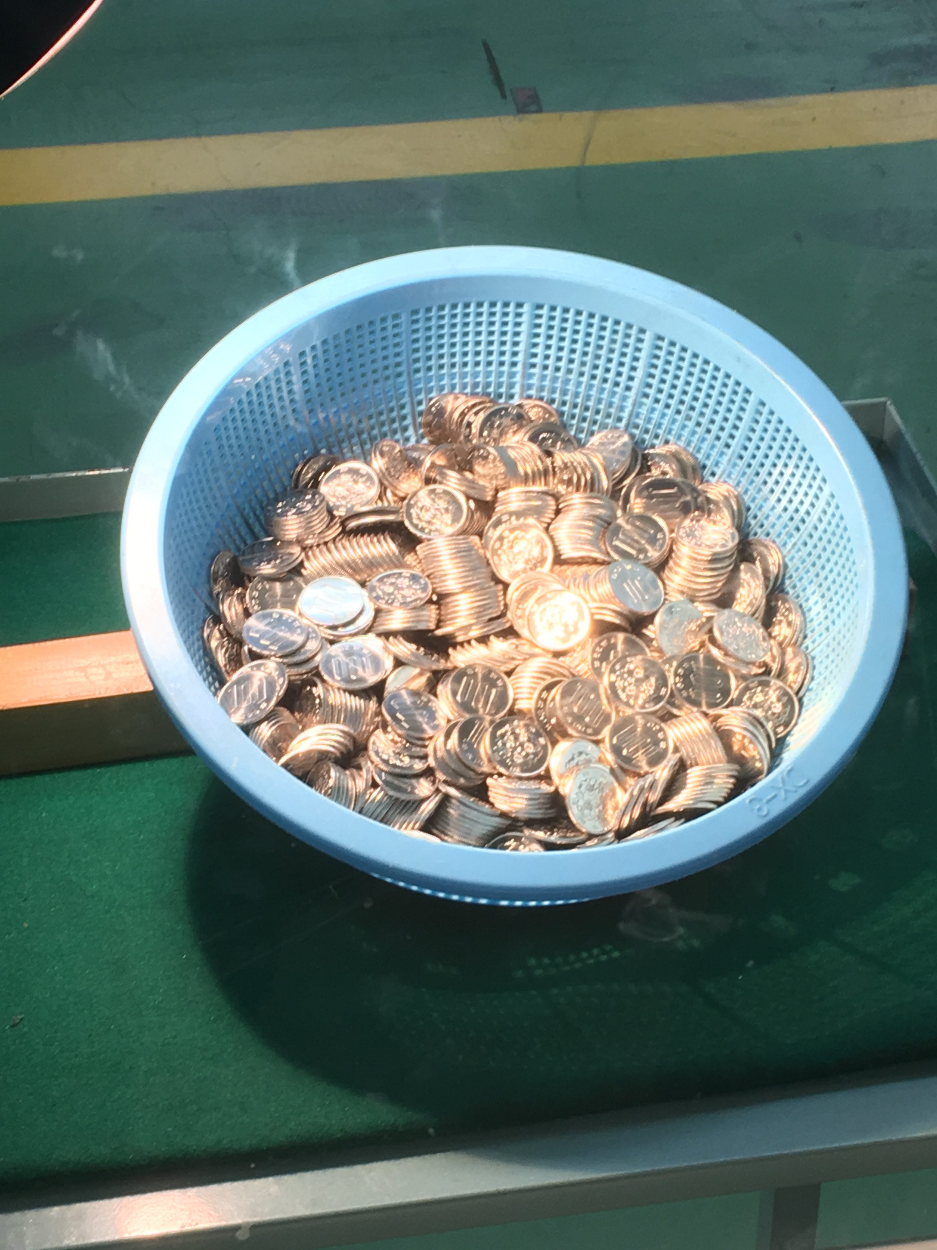 freshly minted 100 yen coins at the Japan Mint
