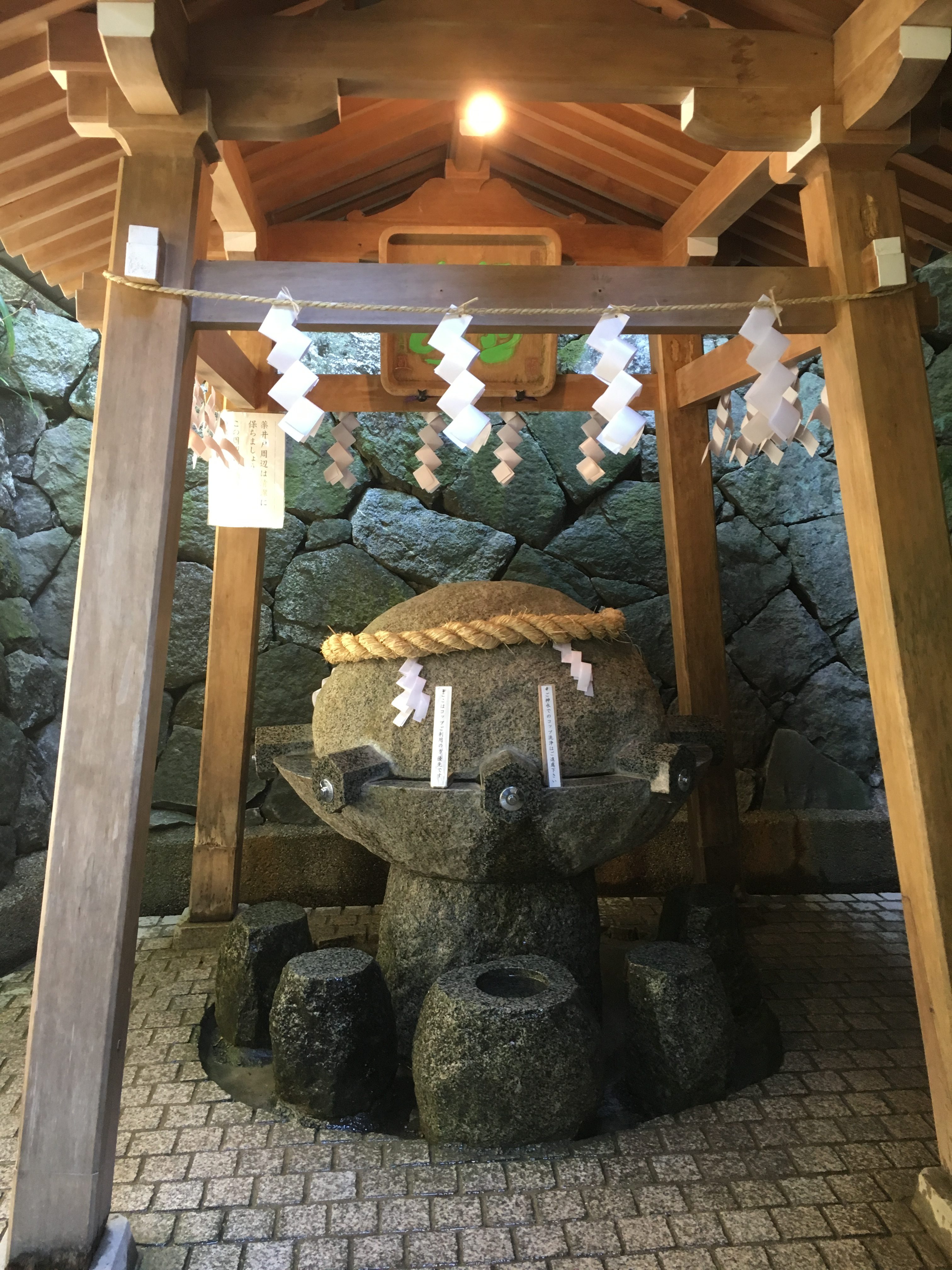 round stone shaped drinking well on Mount Miwa