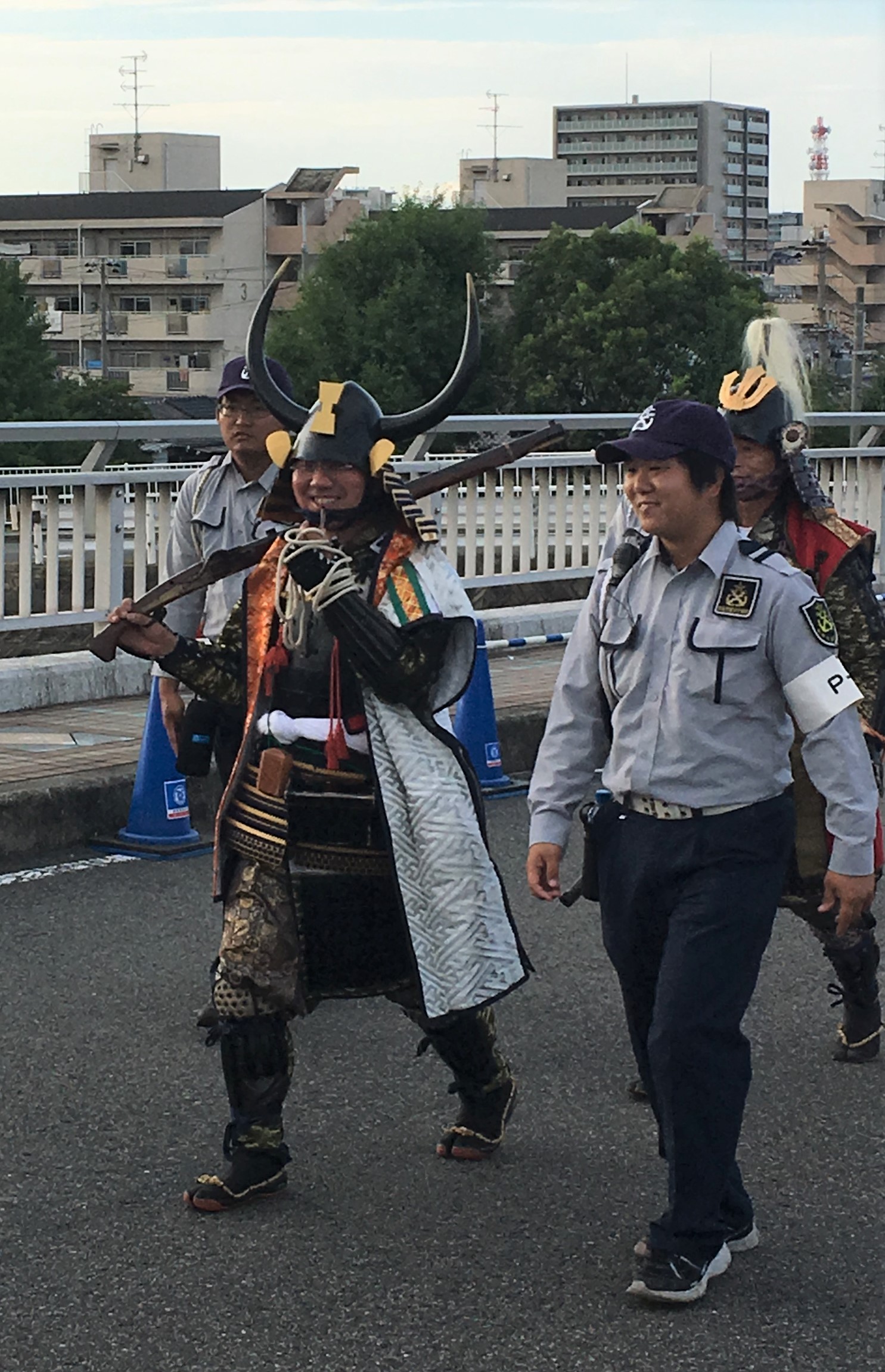 Man in traditional Japanese clothes carrying musket at Sumiyoshi Matsuri