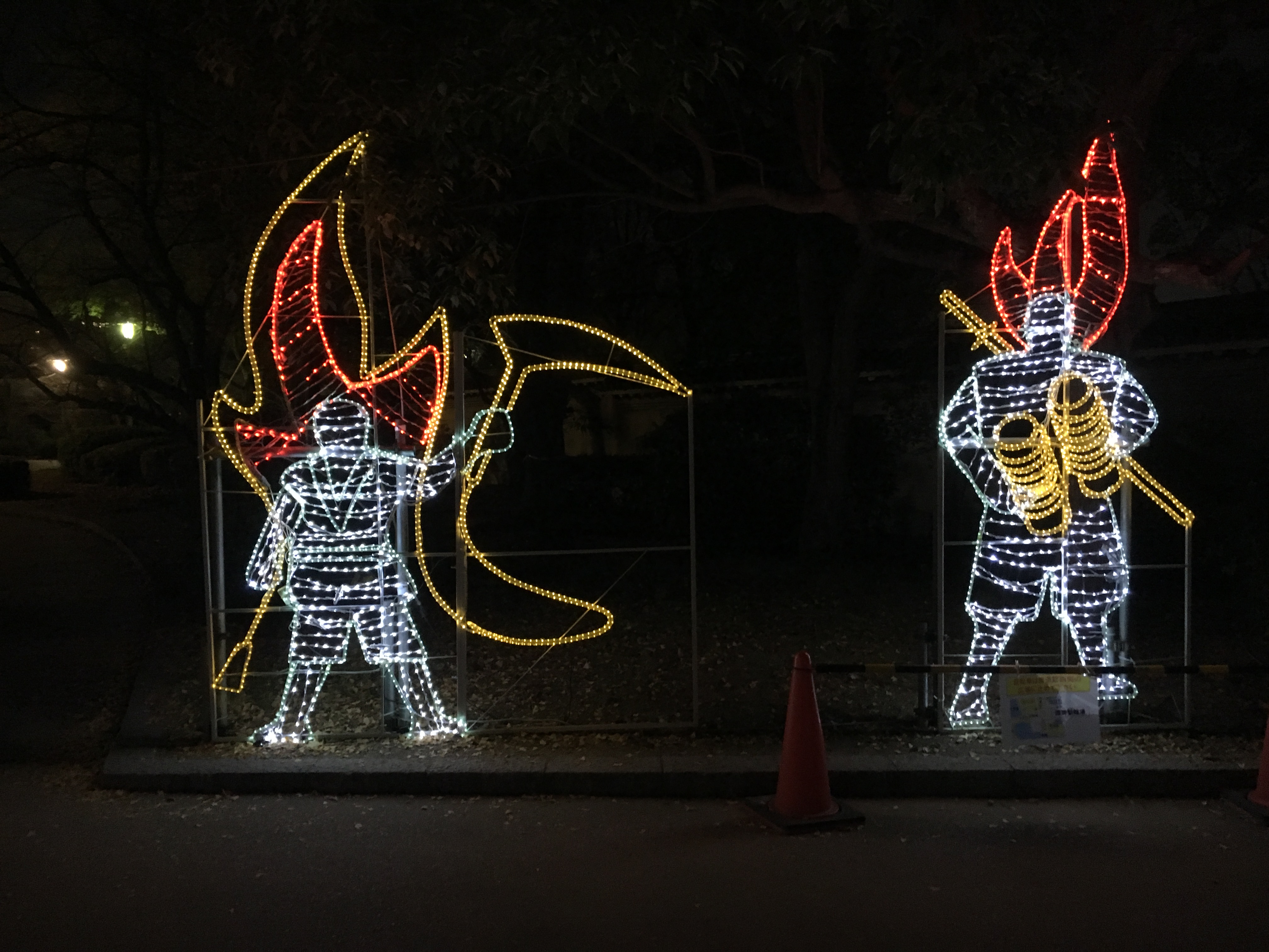white and red illuminated figures in the night