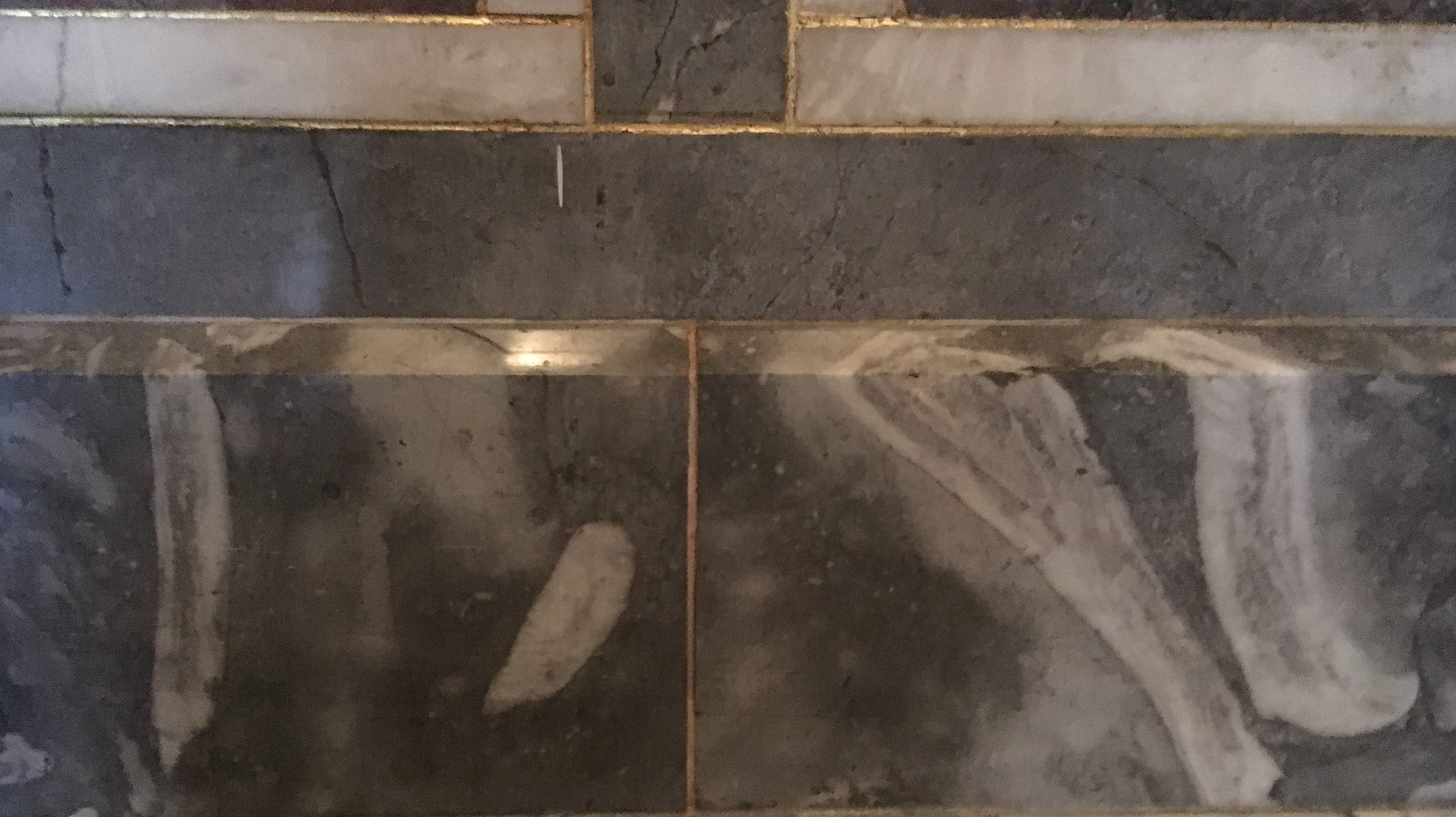 dark grey tiles that contain fossils 