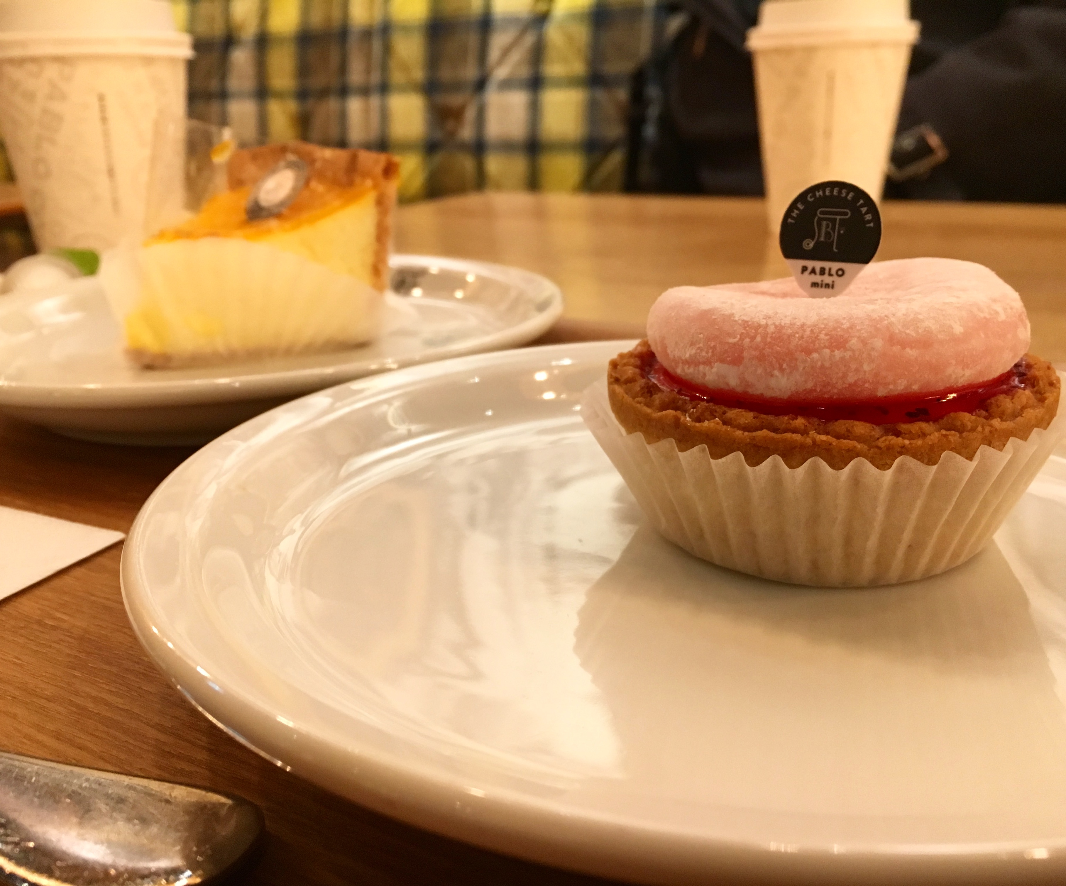 assortment of cheesecakes in a warmly lit Pablo cheesecake cafe