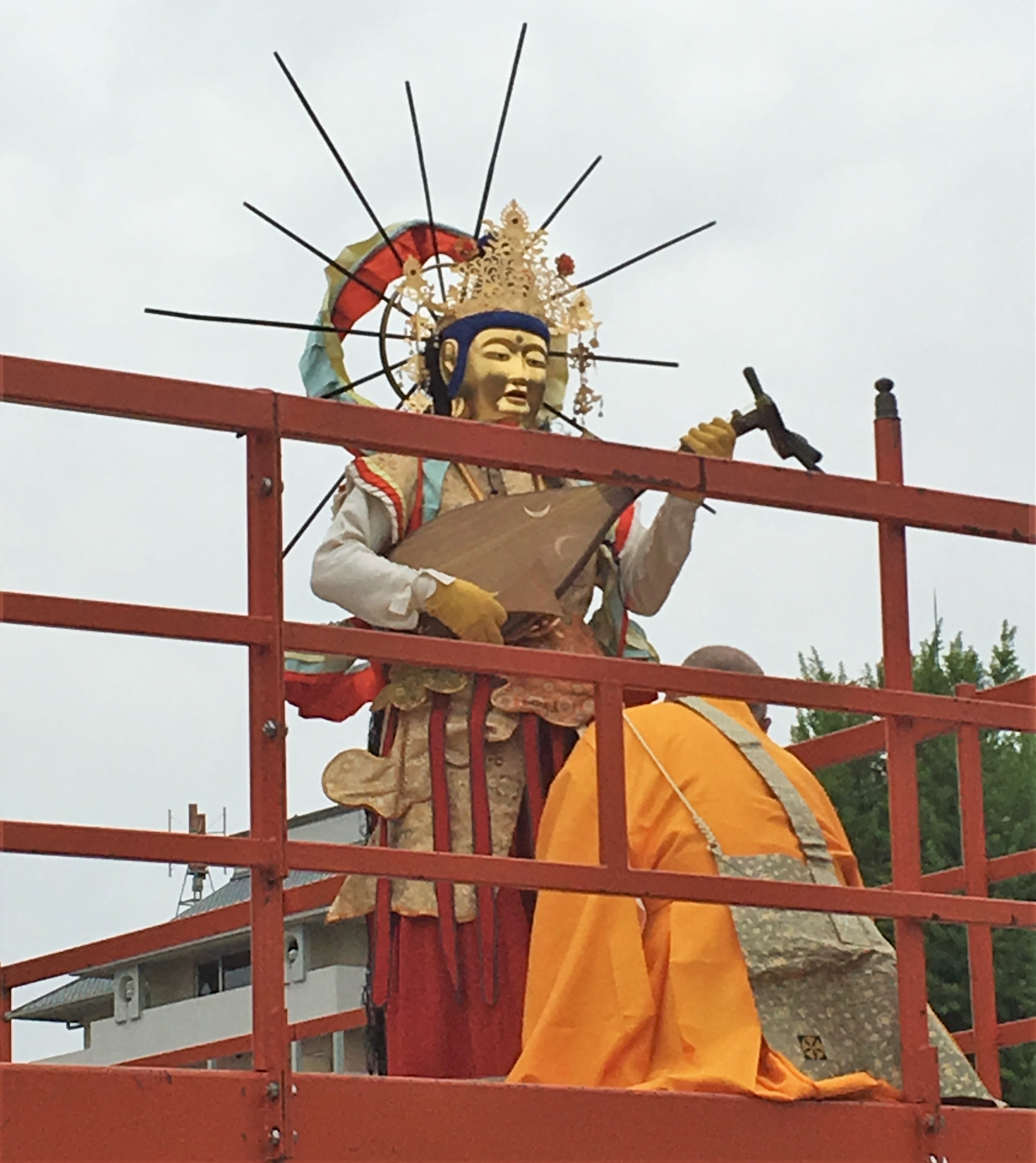 Man dressed as one of the 25 bosatsu carrying an instrument during Manbu Oneri