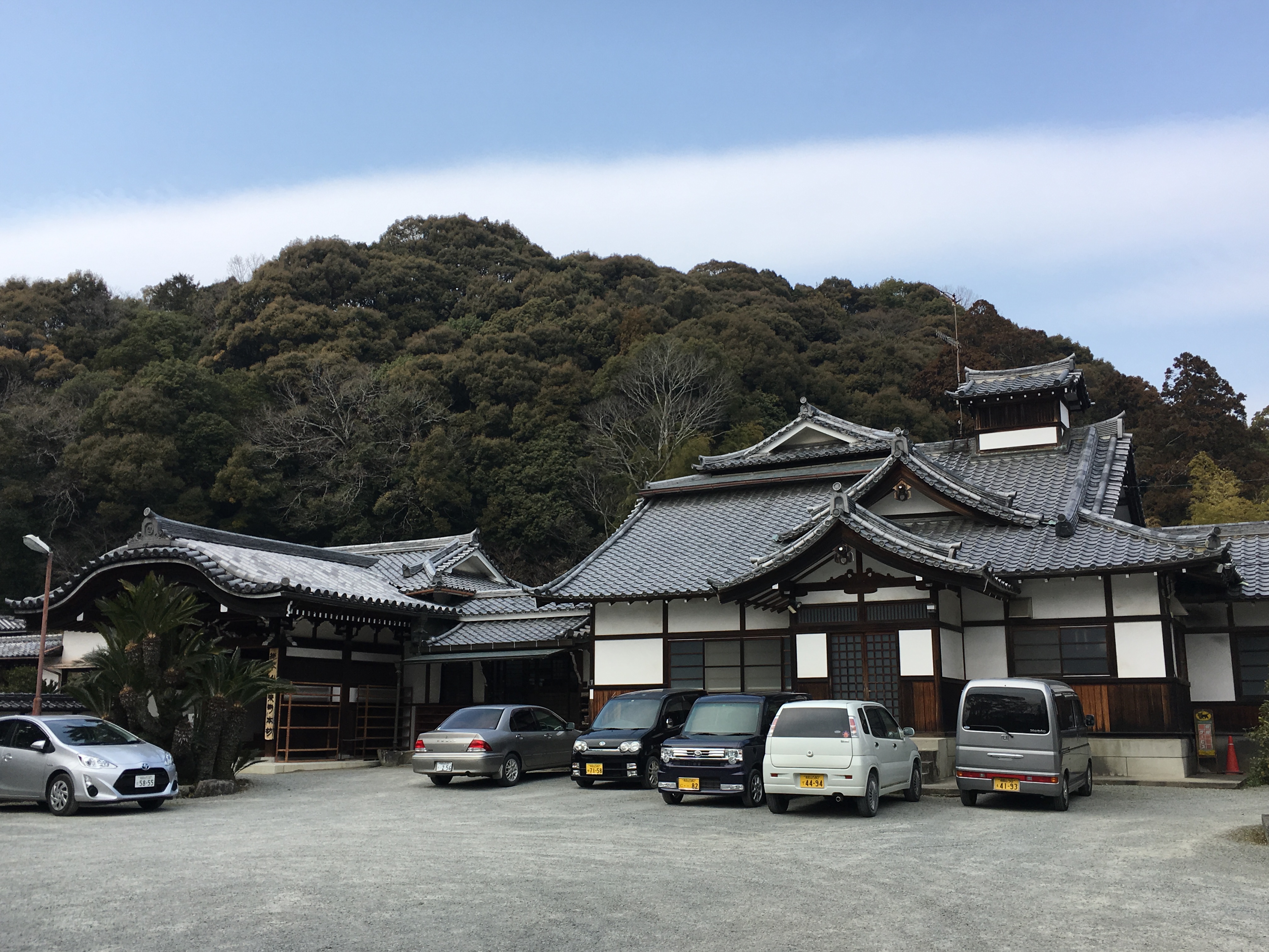 traditional Japanese building with cars parked out front