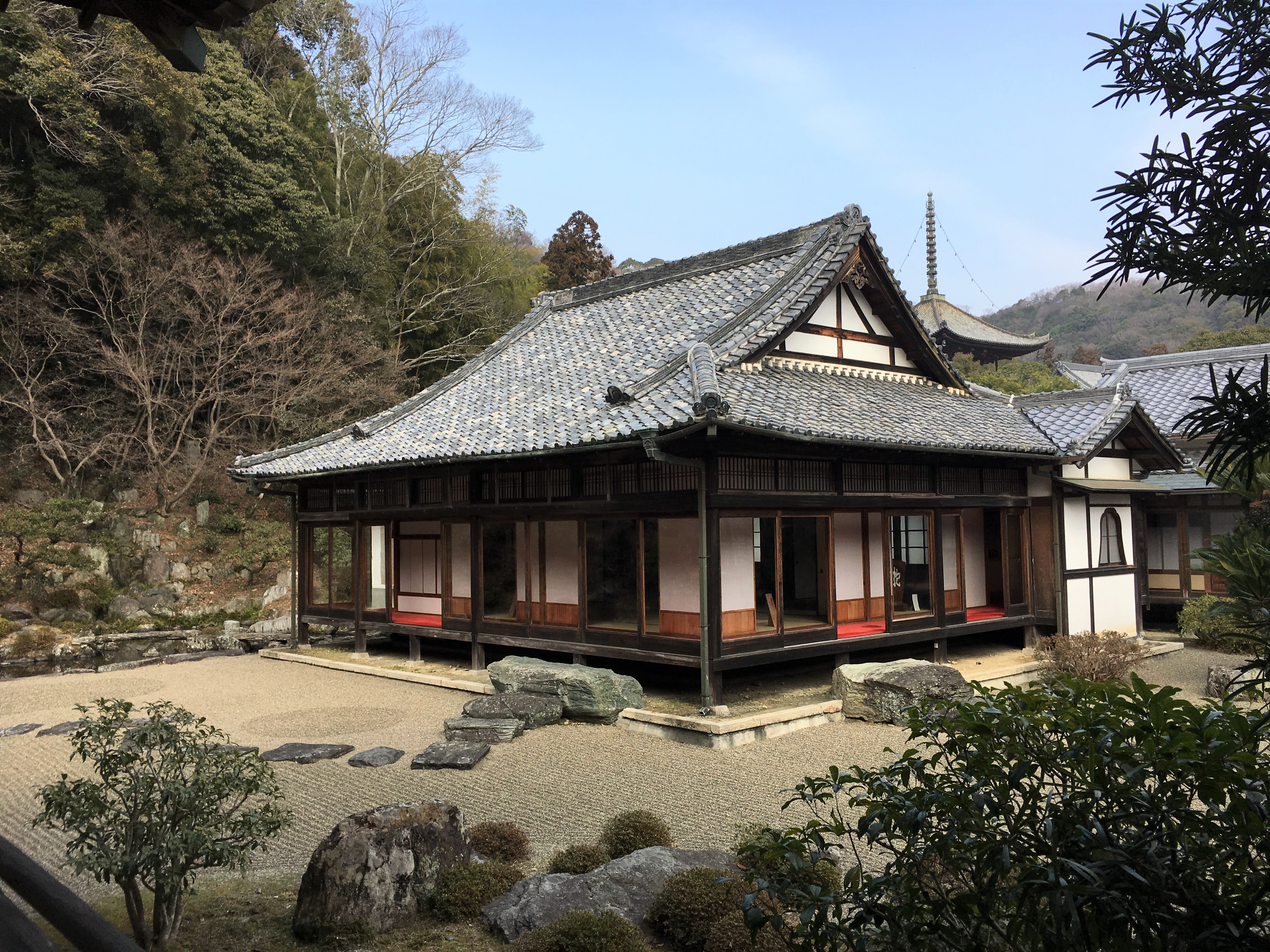 small traditional Japanese style building in a stone garden