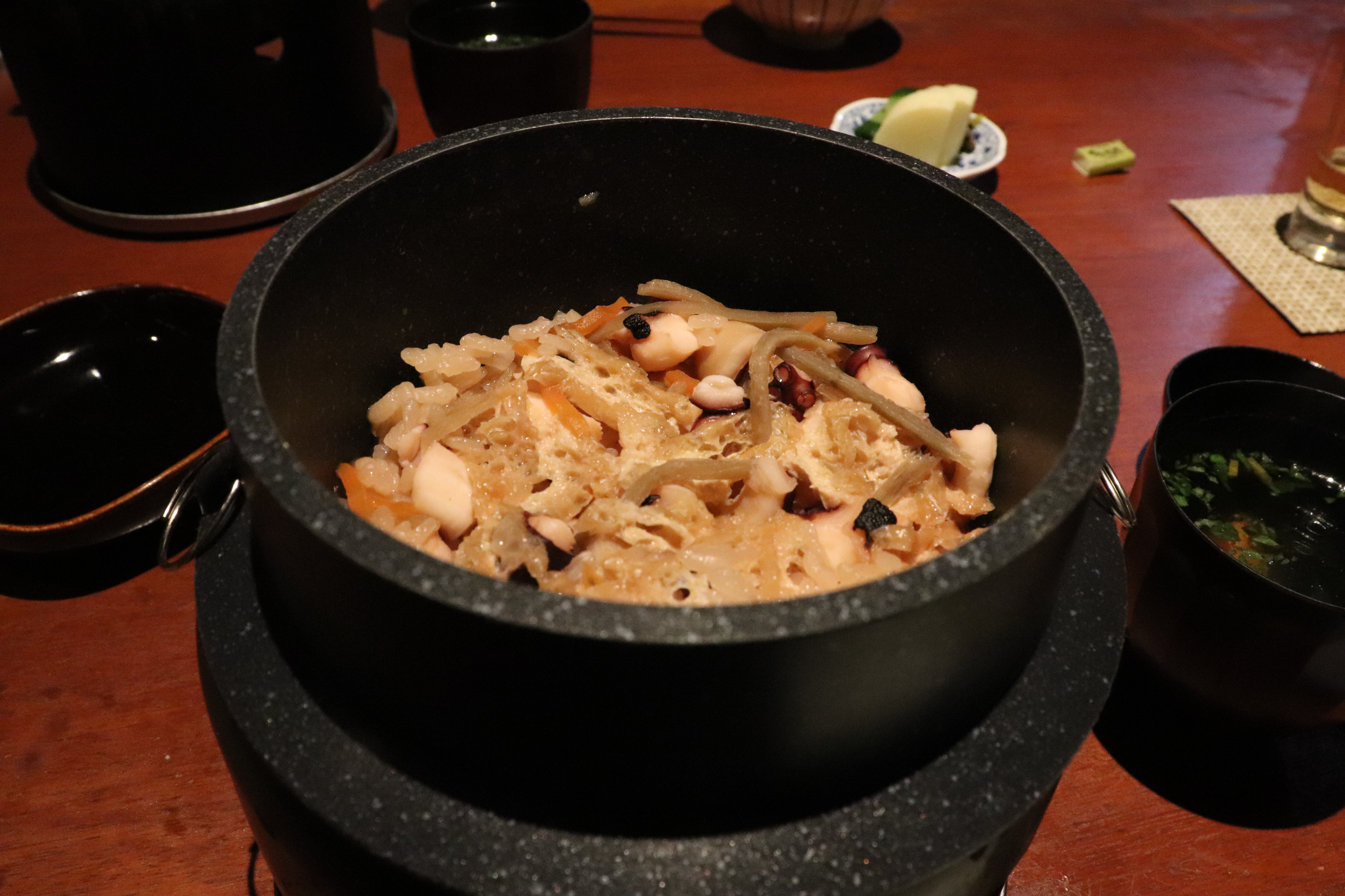rice and octopus cooked in an earthenware pot
