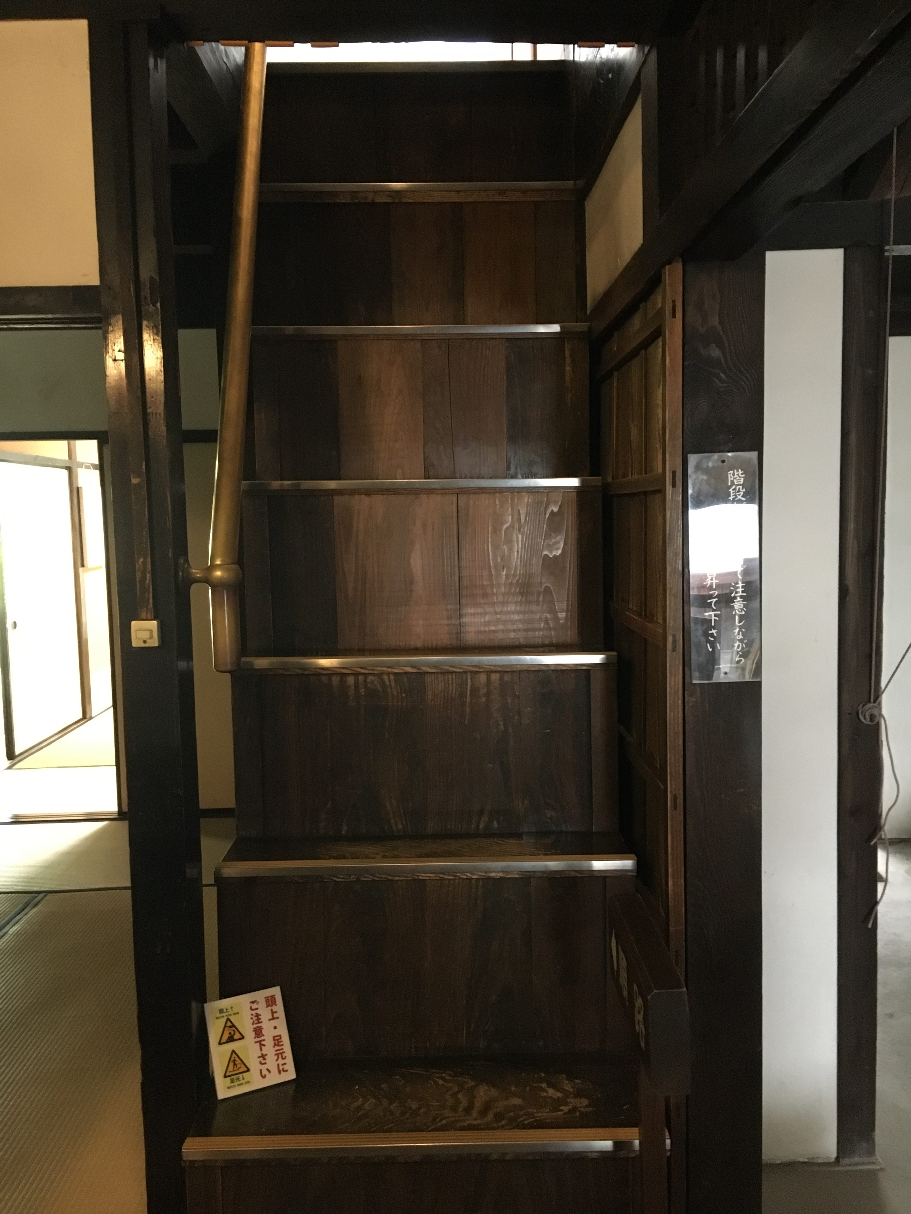 very tall old fashioned Japanese wooden staircase 