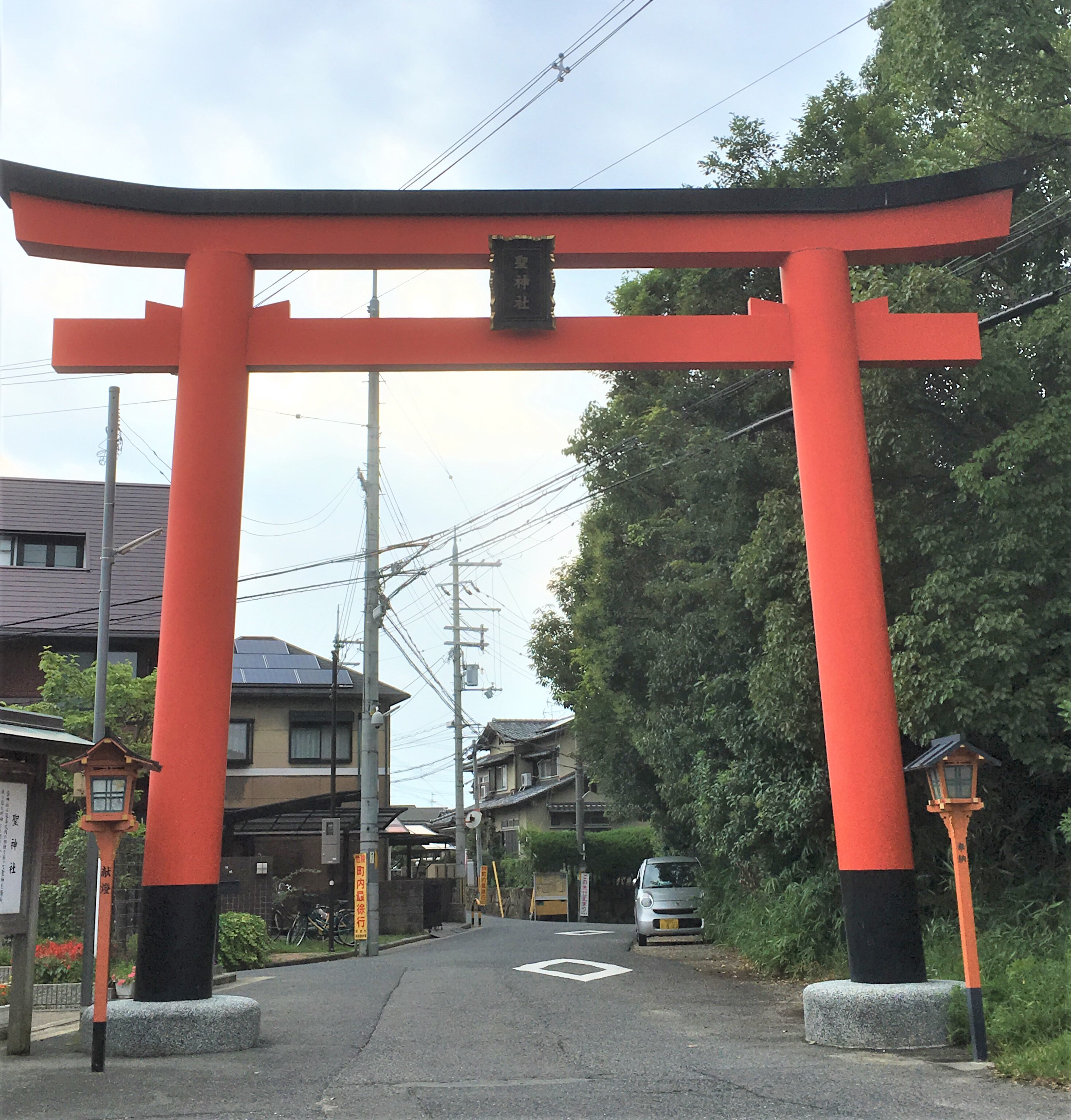 red and black torii leading to hijiri shrine