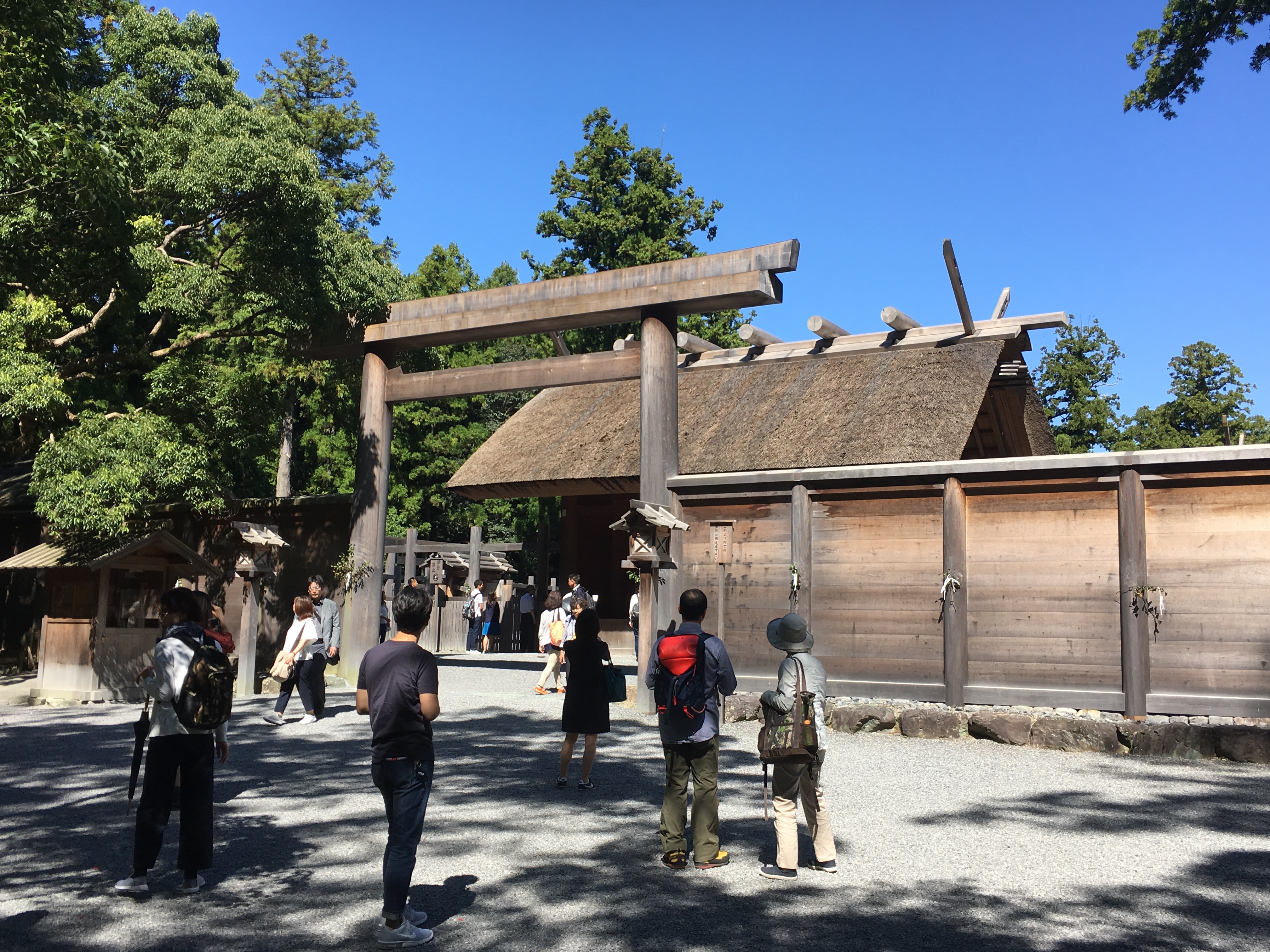 large wooden Japanese shrine in Ise Jingu's geku with visitors