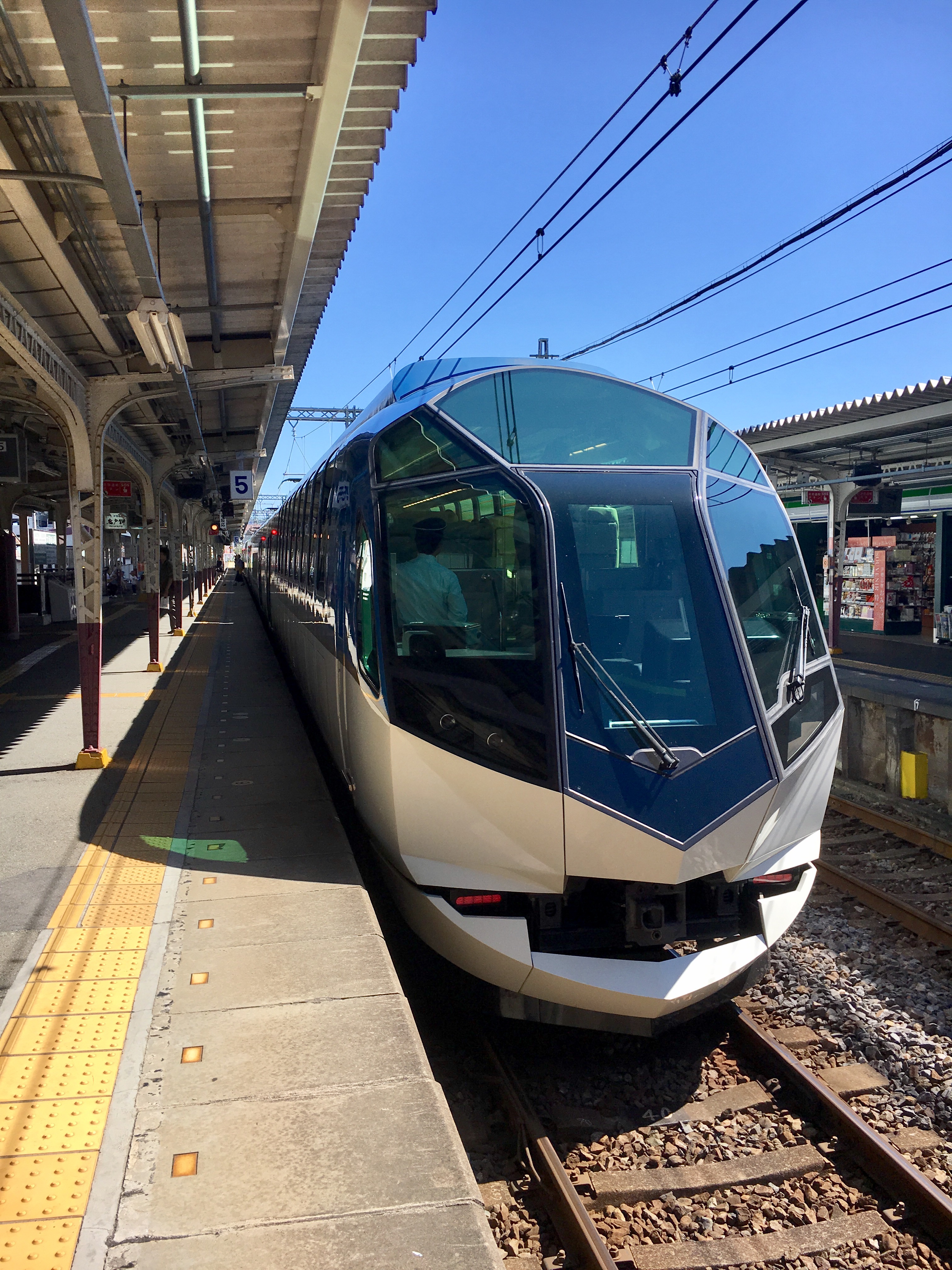 sleek looking train departing station on a clear day