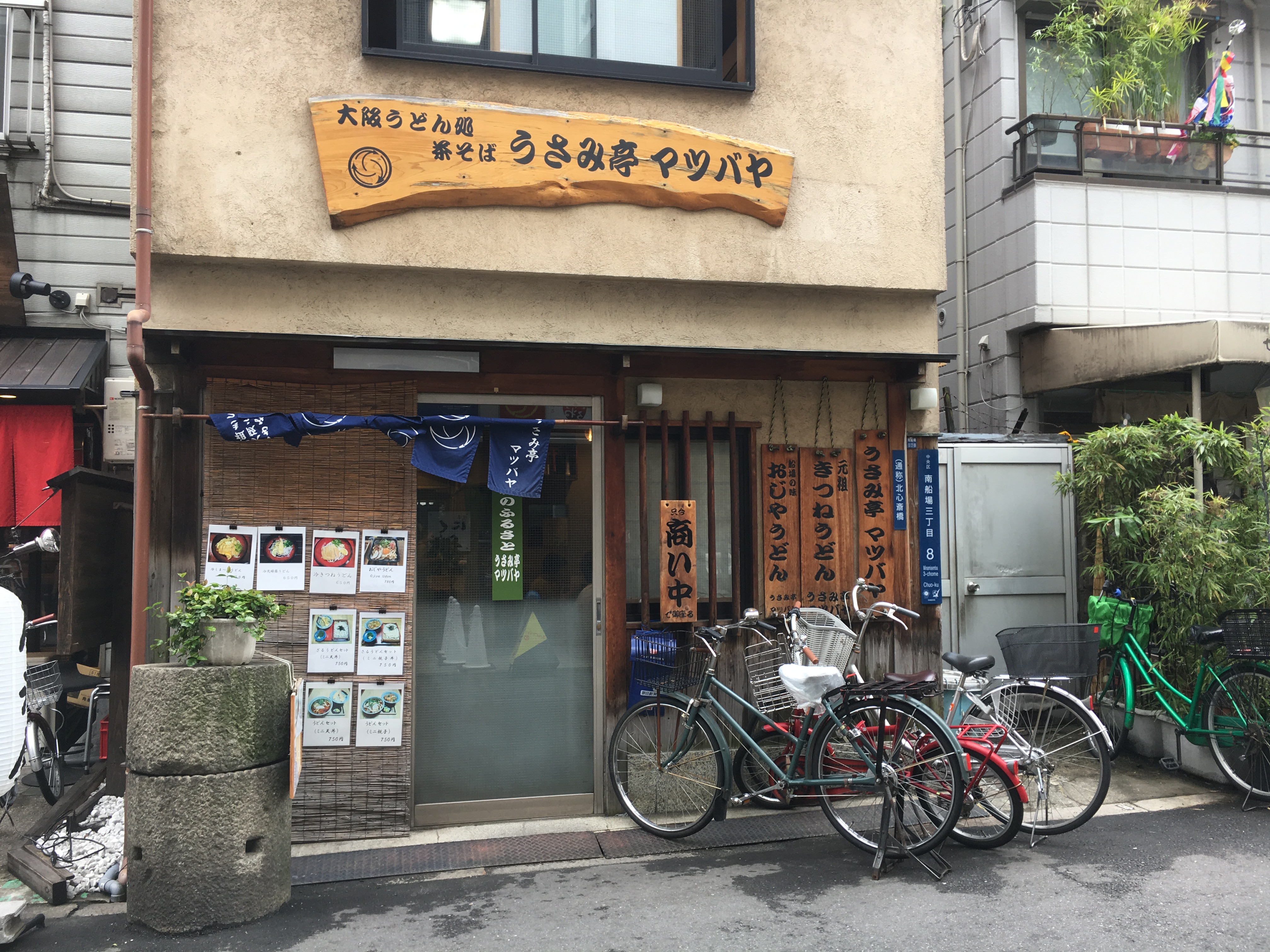 store front of a traditional looking Japanese udon restaurant with bikes parked in front