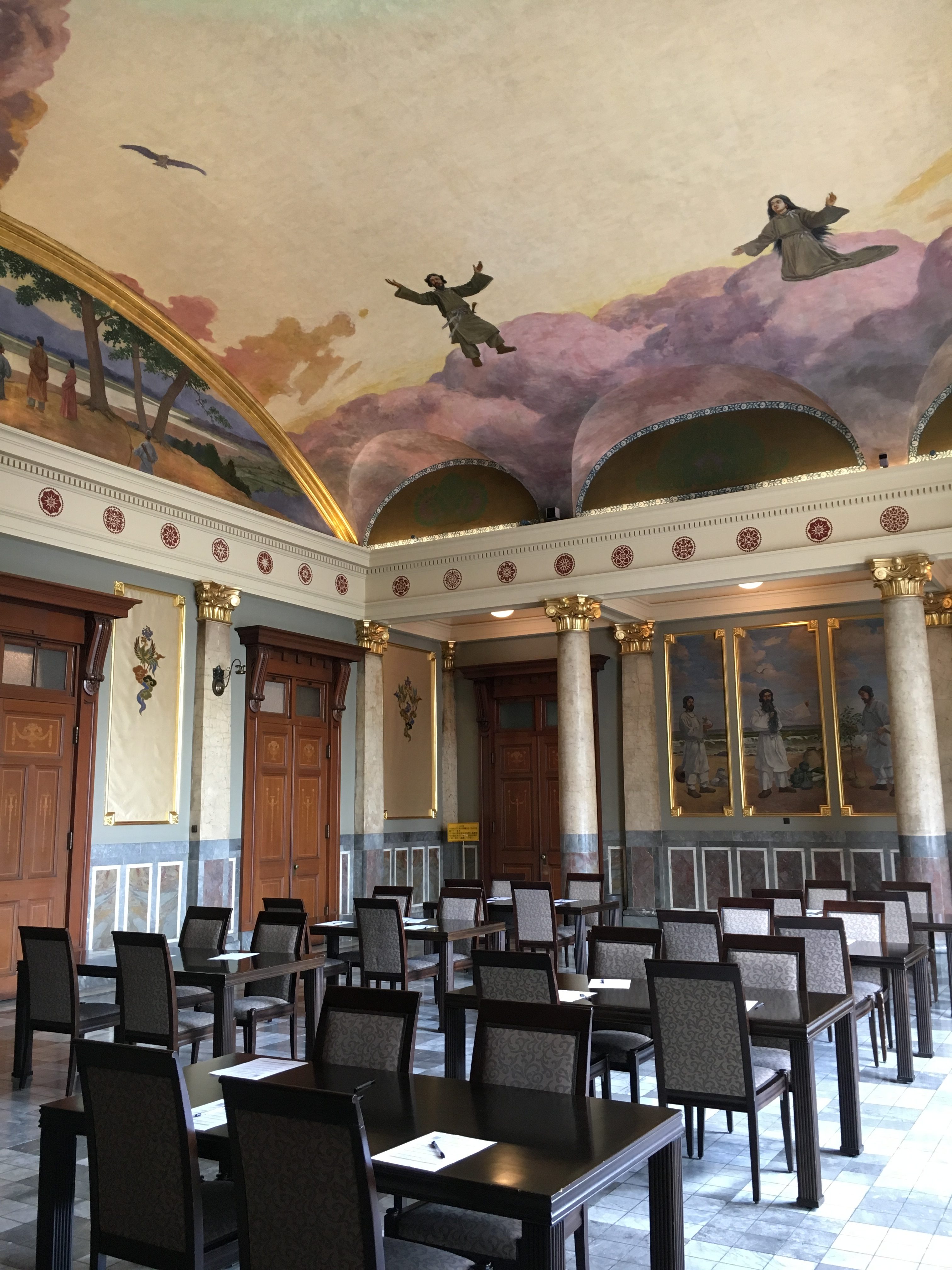 neo-classic style room with high ceiling covered in painted mural