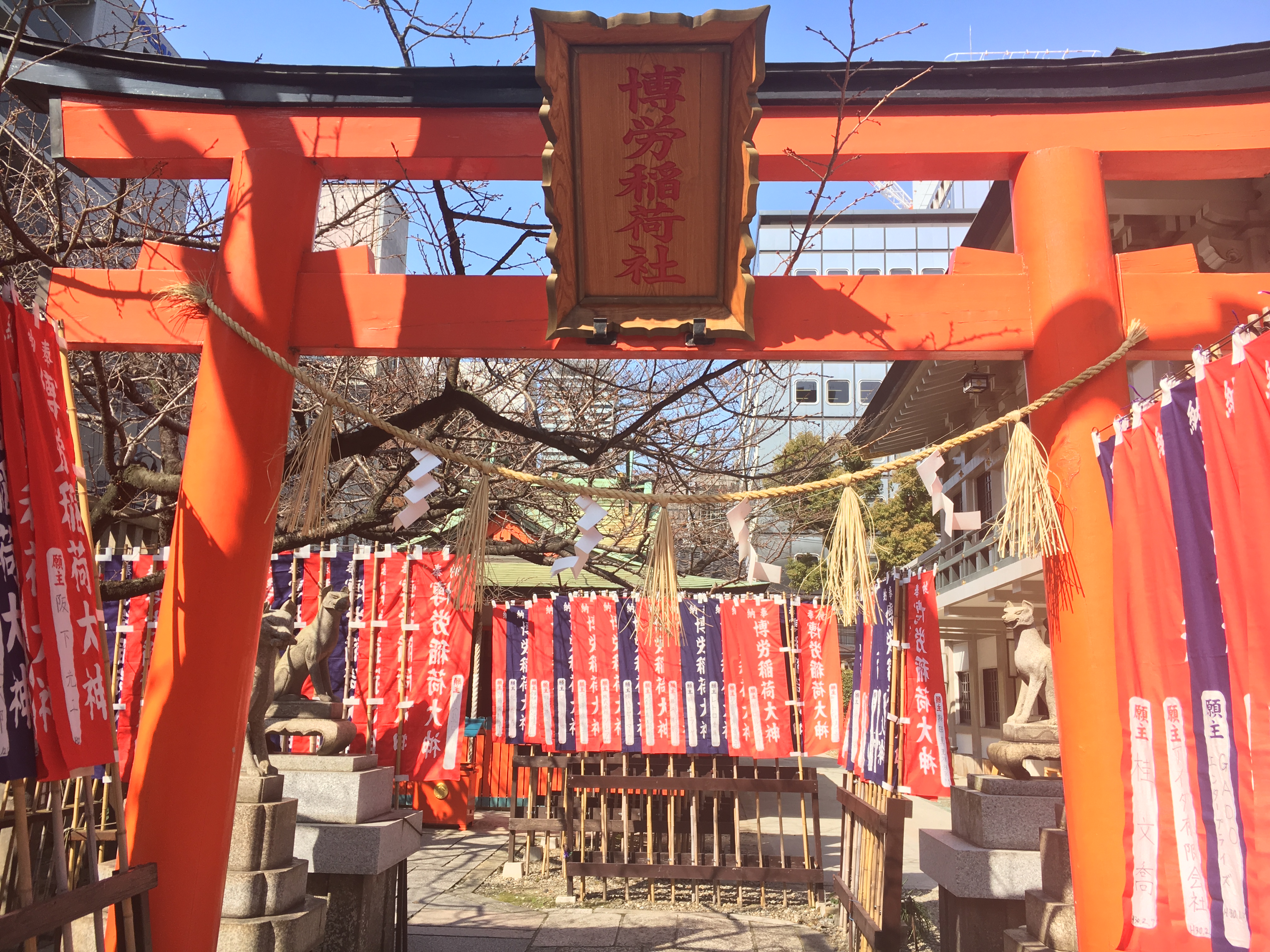 vermillion torii gates of small shrine on midosuji