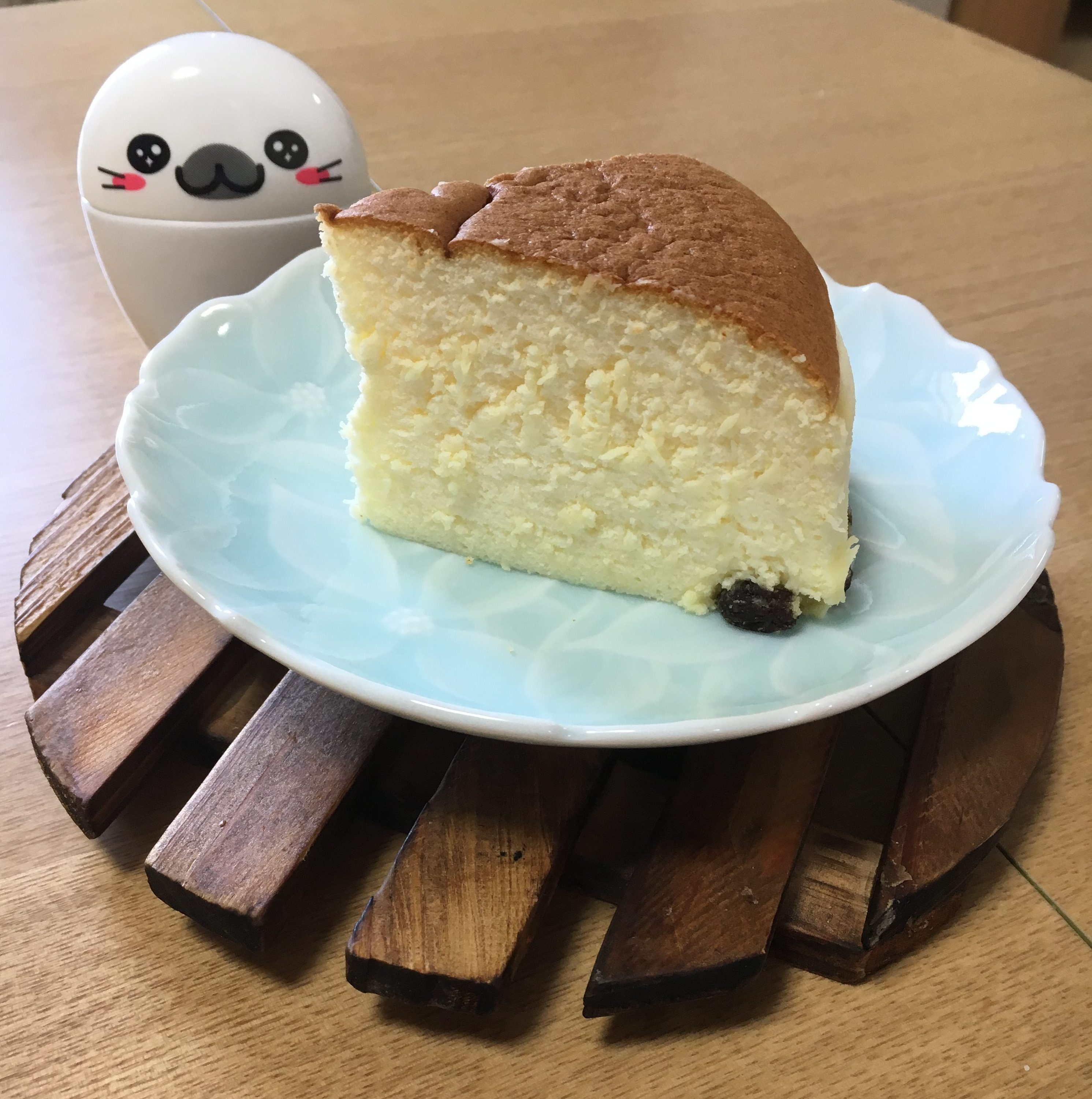 Slice of Rikuro Ojisan souffle cheesecake on a blue plate