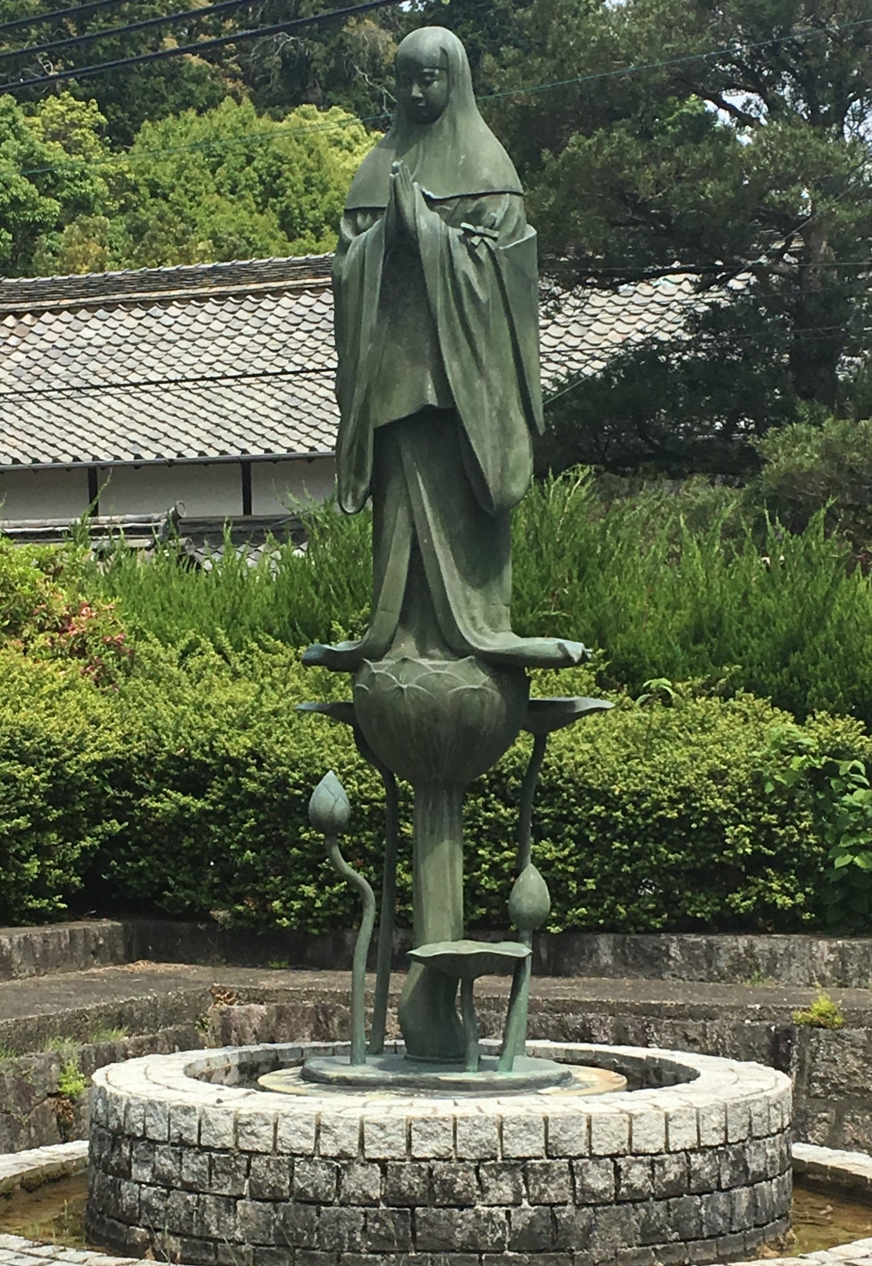 Green statue of princess chujo on a lotus at Taima-dera Temple in Nara