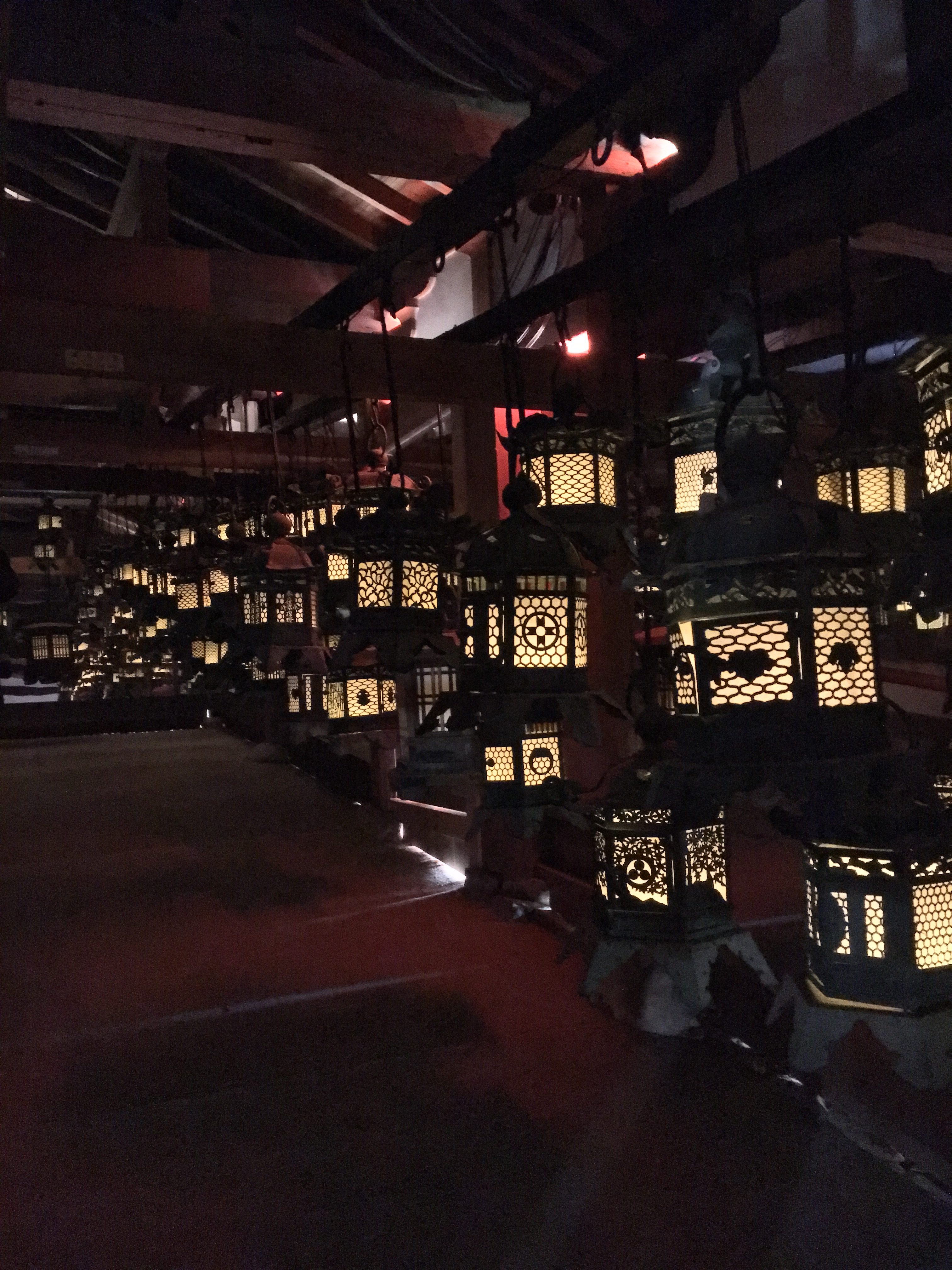 dark room with glowing lanterns in Kasuga Taisha