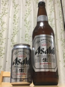 large 500 ml bottle of Asahi beer next to the regular size can