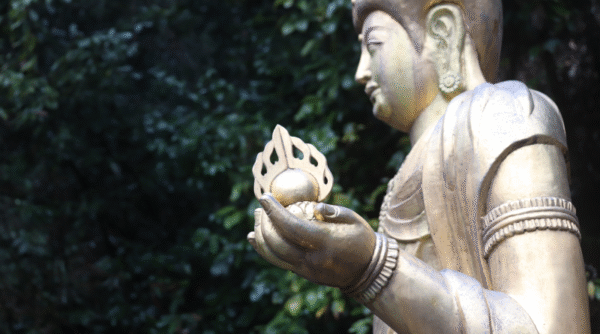 Kannon statue standing outside of the temple